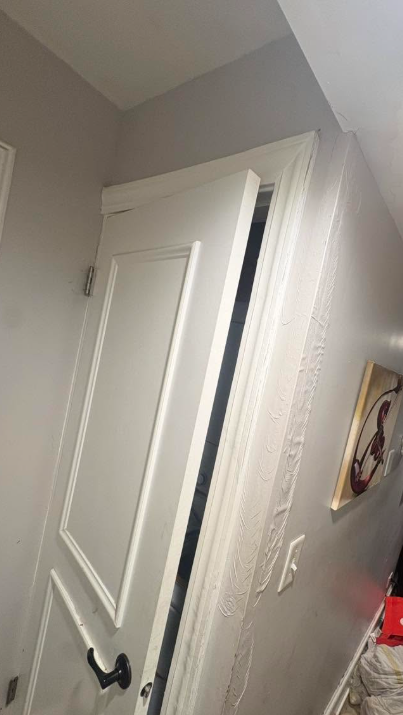 Swollen door casing and bubbling wall surface caused by water damage